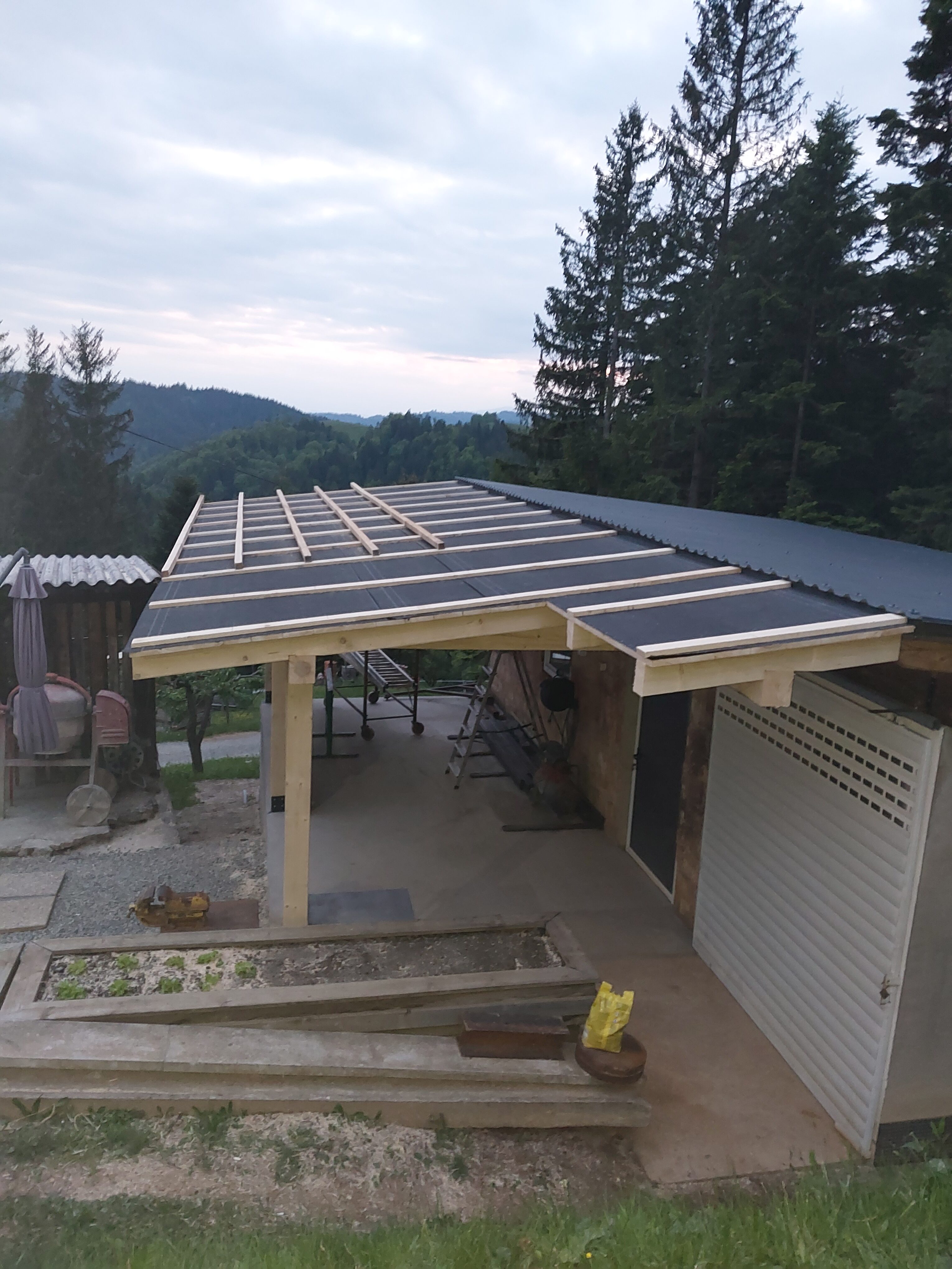 Terrassenüberdachung aus Holz im Bau – Überdachung für Außenbereich mit Blick ins Grüne